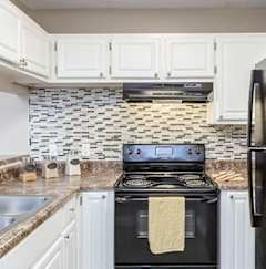 A black refrigerator is on the right side of a kitchen. at Westbury Creek, Augusta, GA, 30909