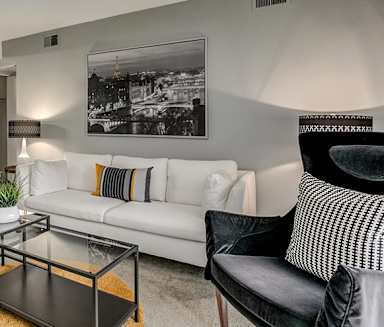 a living room with a white couch and a glass table at Aspen Landing, Kansas City, Missouri