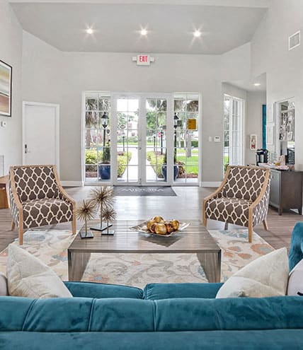 a living room with three mirrors and a wood floor