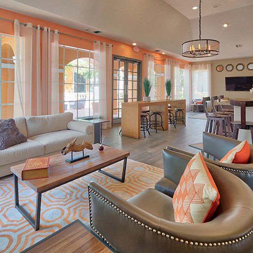 a living room with blue couches and chairs and a fireplace
