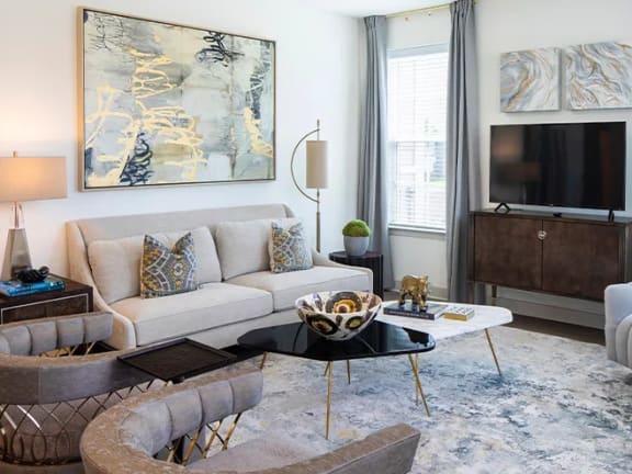 a living room with a couch chair and coffee table at Canopy at Ginter Park Apartments, Richmond, VA, 23227