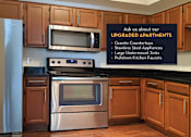 Thumbnail 3 of 50 - Luxury apartments with spacious kitchens, black granite countertops, stainless steel appliances, honey brown toned cabinets, and side-by-side refrigerators at The Lanesborough Apartments in Houston