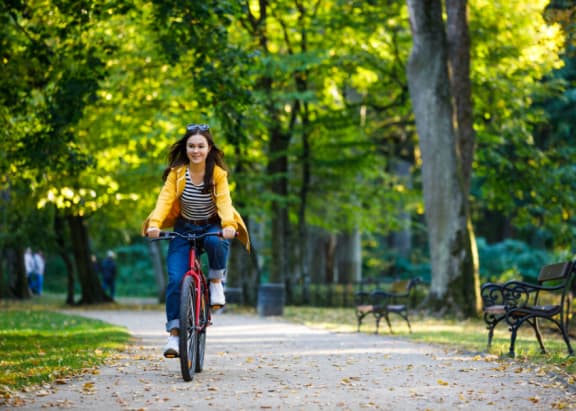a woman riding a bike in a park
