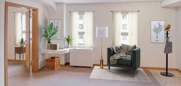 A living room with a green couch and a white table.