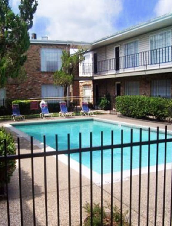 a swimming pool in front of an apartment building