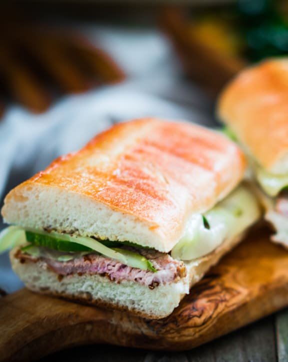 a sandwich cut in half on a cutting board District West Gables West Miami, FL