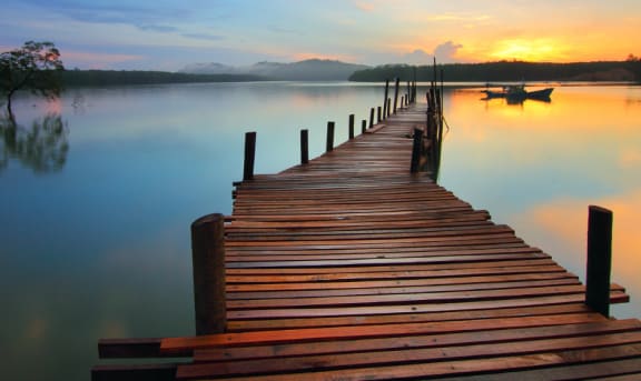 A dock on a lake with a sunset in the background  at Palm Crossing, Florida, 34787