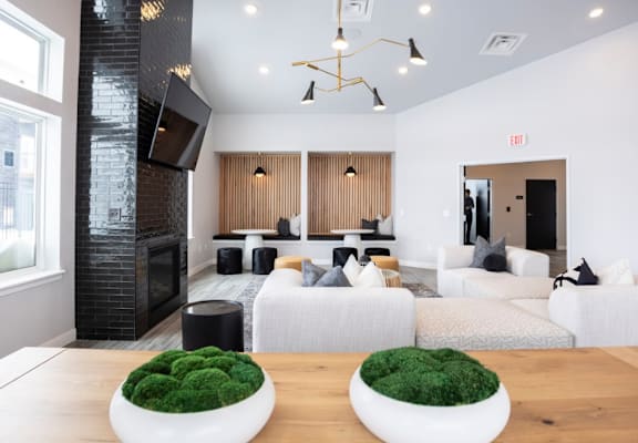 A modern living room with a fireplace and a large couch.