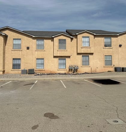 A large building with a parking lot in front of it.