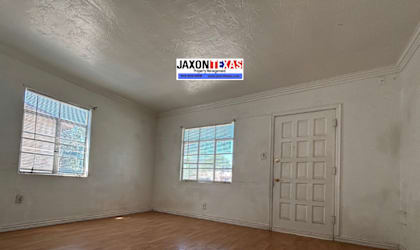 A room with wooden floors and a white door.