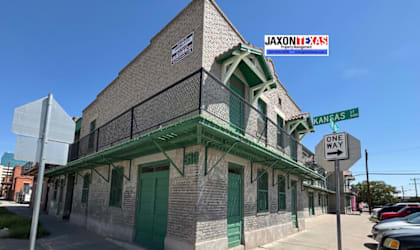A building with a green awning and a sign that says "Jaxonix" on it.