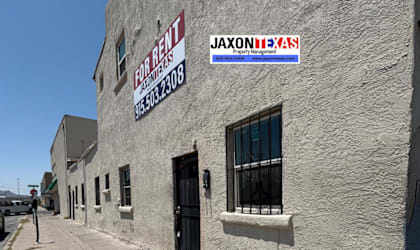 A building with a for rent sign on it.