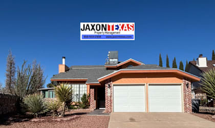 A house with a sign that says "Jaxon HAAS Property Management" in front of it.
