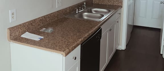 a kitchen with white cabinets and granite countertops