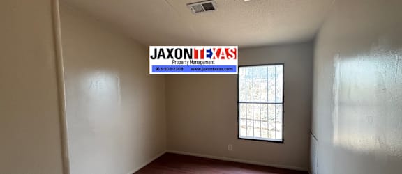 A room with a ceiling fan and a window.