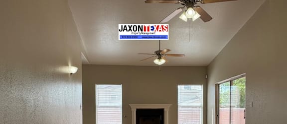 A room with a JAXON HEYAS sign on the ceiling.