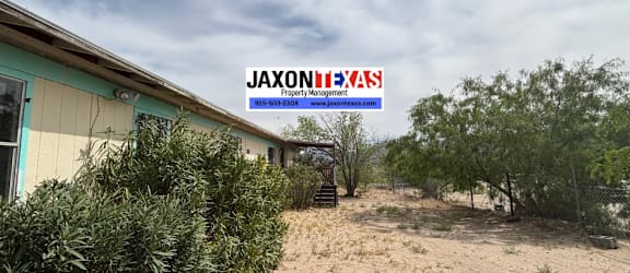 A deserted property with a sign that reads "JaxonTexas".
