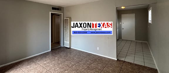 A room with a JAXON PROPERTY MANAGEMENT sign on the wall.