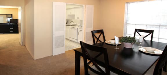 Spacious dining room and bright white kitchens at Plantation apartments in Houston.