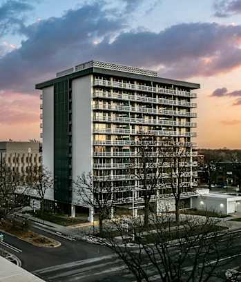 a tall building with a sunset in the background