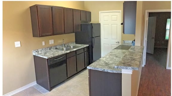 a kitchen with an island and a refrigerator