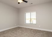 Thumbnail 35 of 48 - an empty room with a window and a ceiling fan
