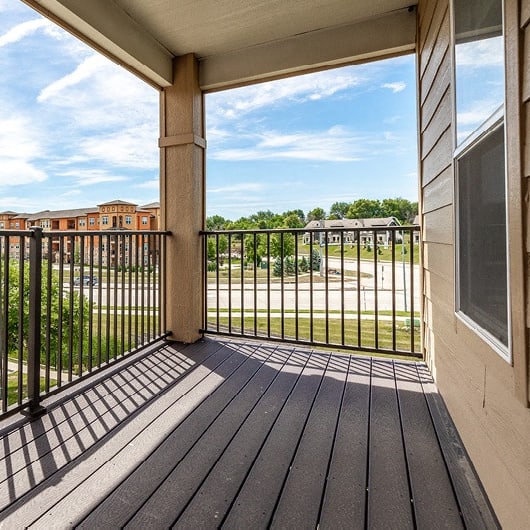 the view of the parking lot from the balcony of an apartment building