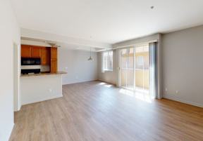 Living Area with Wood Floors, Bartop, & Sliding Glass Doors to Private Patio