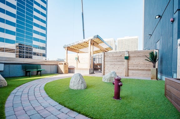 a roof garden with a fire hydrant and grass