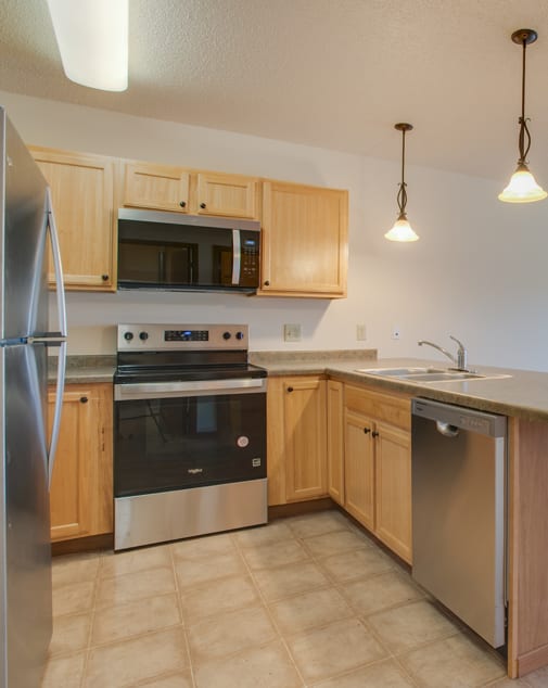 a kitchen with white appliances and brown walls