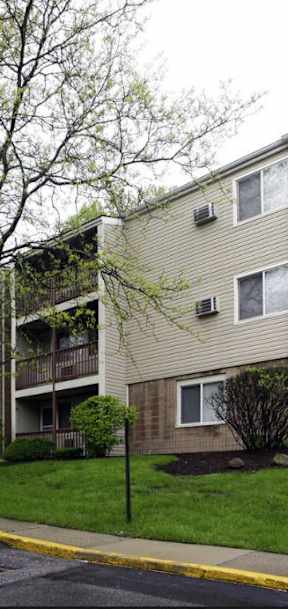 a street view of an apartment building on a rainy day