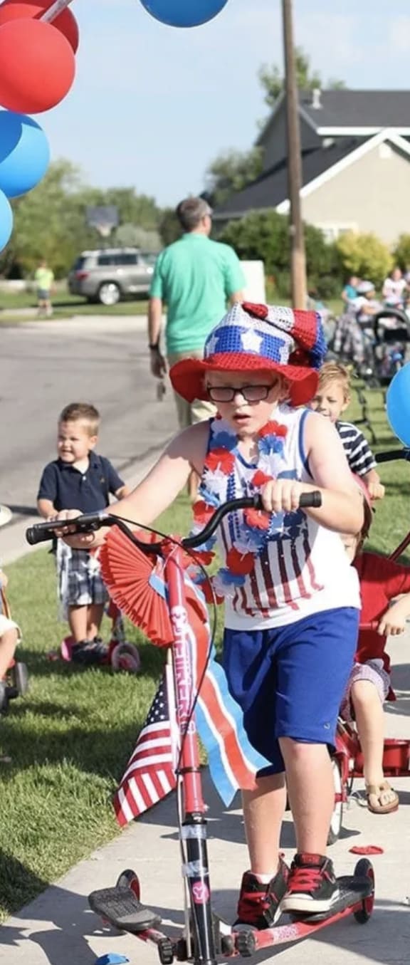 Children enjoying riding bikes down a sidewalk at Belle Creek Apartments, Henderson, CO, 80640