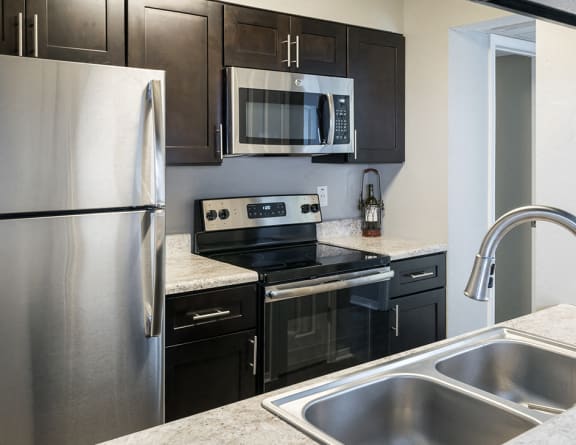 Fully-Equipped Modern Kitchen with Stainless Steel Appliances with Granite Countertops