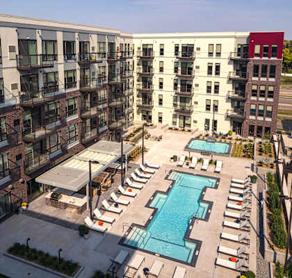 an aerial view of an apartment building with a swimming pool