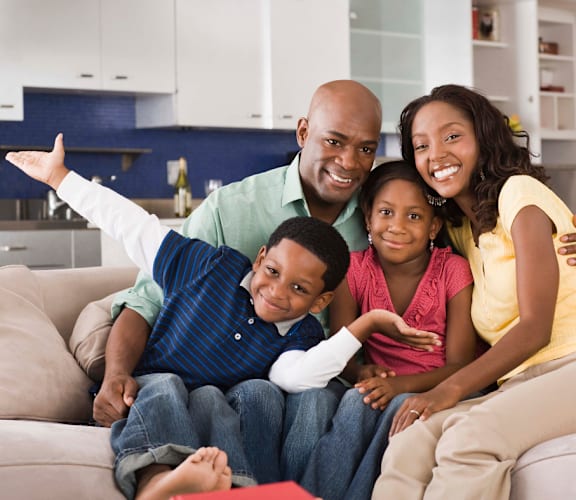 a family of four sitting on a couch