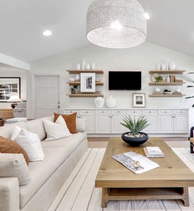 a living room filled with furniture and a large chandelier