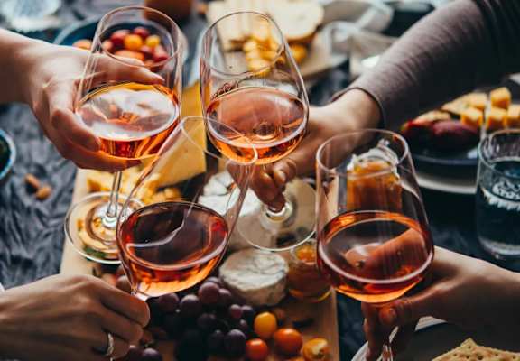 A group of people toasting with glasses of wine.