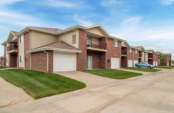 Exterior of Northbrook Apartments with attached garages and lawns