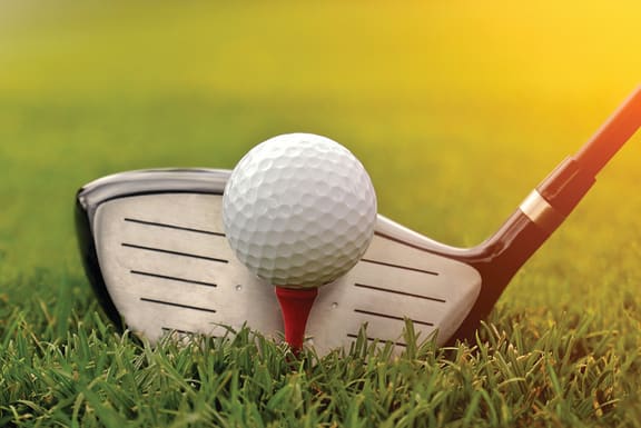 a golf club with a golf ball on top of it