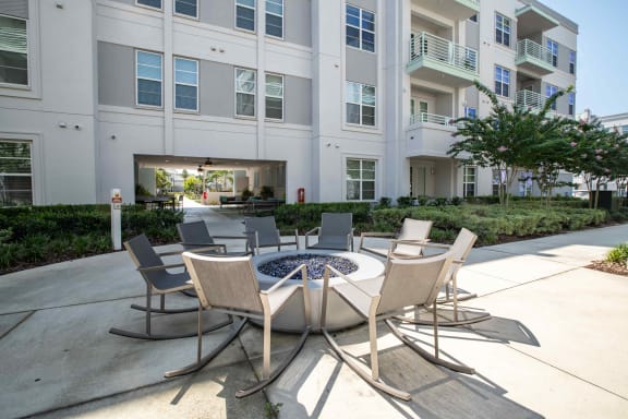 a patio with a firepit and chairs in front of an apartment building at Celebration, Florida, 34747