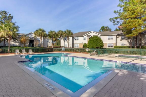 Sparkling blue swimming pool with tanning deck
