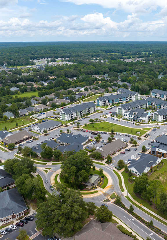 A bird's eye view of a residential area with houses and roads.