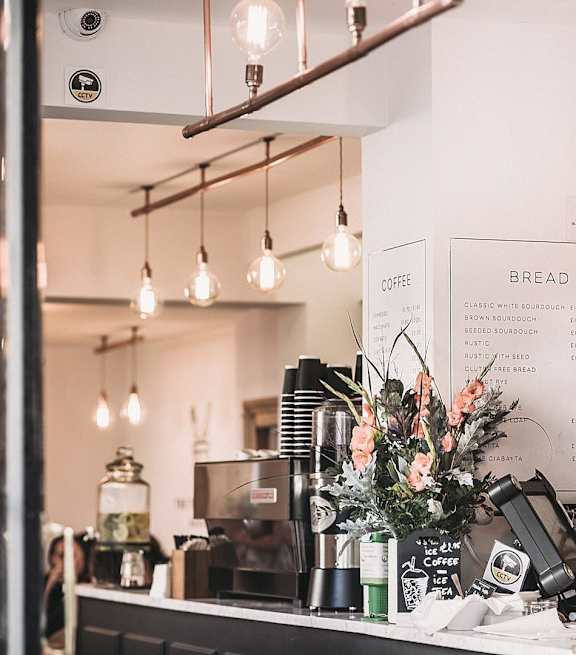 A coffee shop with a counter and a sign that says bread.