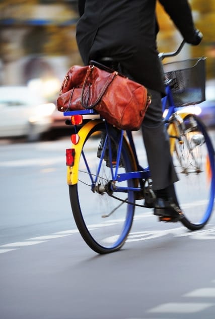 person riding a bike on the city street