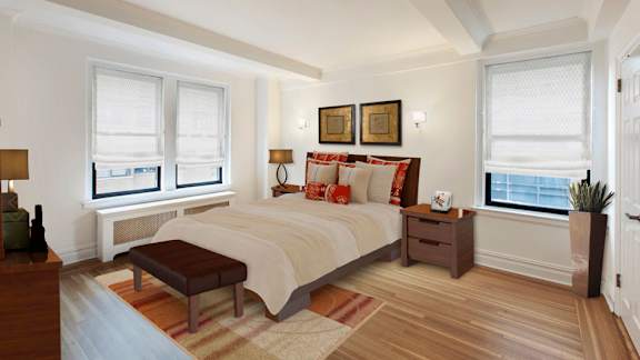 A bedroom with a large bed and a window with a view of the city.at Sutton Collection, New York New York