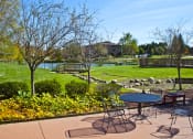 Thumbnail 15 of 15 - Patio overlooking the pool and pond at  Integrity Medina Apartments, Integrity Realty LLC, Medina