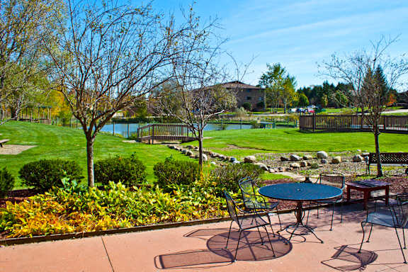 Patio overlooking the pool and pond at  Integrity Medina Apartments, Integrity Realty LLC, Medina