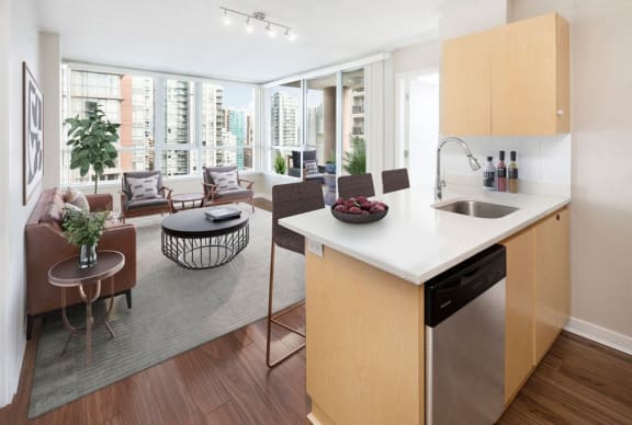 Beautifully staged one-bedroom apartment, looking from the kitchen straight through to the view.