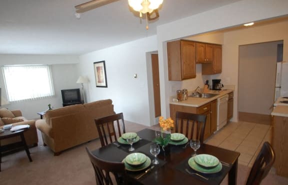 a dining room and living room with a table and chairs