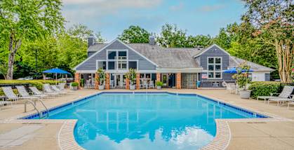 A large house with a pool in front.